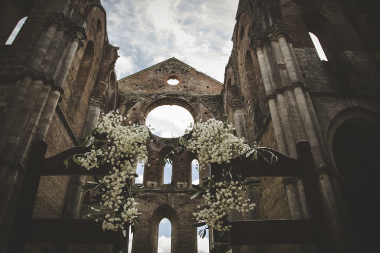 Outdoor Ceremony Historic Location White Gypsophila Wooden Chairs Atmospheric Abbey Tuscany Wedding http://www.angelicabraccini.com/