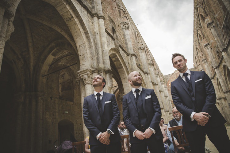 Outdoor Ceremony Groom Polka Dot Tie Groomsmen Navy Blue Suits White Pocket Squares Guests Atmospheric Abbey Tuscany Wedding http://www.angelicabraccini.com/