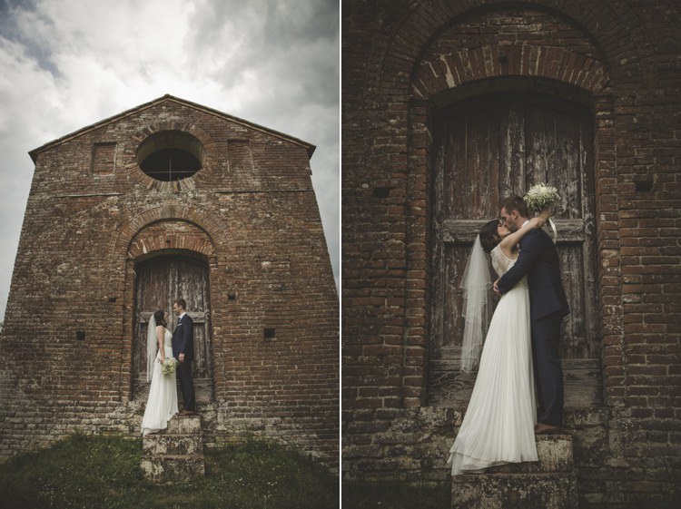 Historic Brick Building Bride Lace Sleeveless Bridal Gown Loose Curls Veil Bouquet Cream Roses Gypsophila Groom Navy Blue Suit Polka Dot Tie Atmospheric Abbey Tuscany Wedding http://www.angelicabraccini.com/