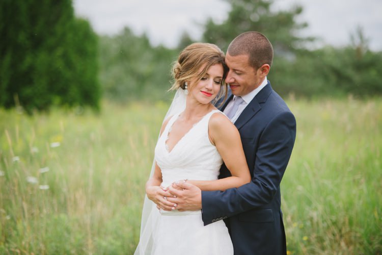 Bride Lace V Neck Bridal Gown Veil Earrings Red Lipstick Groom Navy Suit Light Blue Tie Trees Grass Romantic Fresh Outdoor Wedding Ontario http://www.rebeccabose.com/