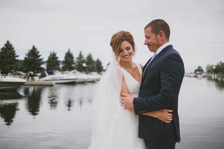 Bride Lace V Neck Bridal Gown Veil Red Lipstick Groom Navy Suit Light Blue Tie Marina Trees Water Romantic Fresh Outdoor Wedding Ontario http://www.rebeccabose.com/