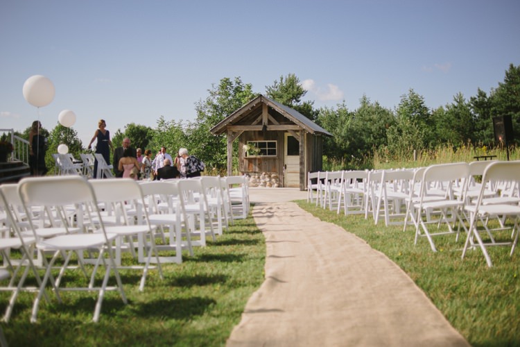 Outdoor Ceremony Location Wooden Rustic Hut White Chairs Grass Hessian Aisle Runner Romantic Fresh Outdoor Wedding Ontario http://www.rebeccabose.com/