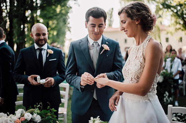 Ceremony Ring Exchange Bride Lace Halter-Neck Top Tulle Skirt Groom Grey Suit Silver Tie Groomsmen Guests Outdoor Floral Countryside Wedding Veneto http://serenagenovese.com/