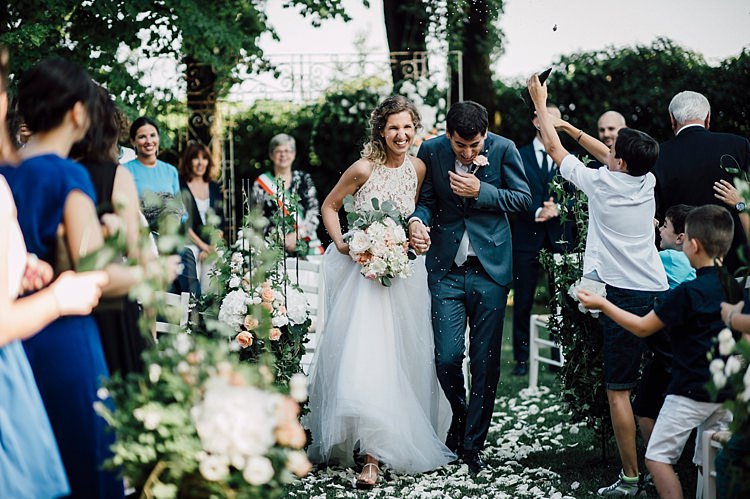 Ceremony Bride Lace Halter-Neck Top Tulle Skirt Bouquet White Peach Roses Peonies Groom Grey Suit Silver Tie Guests Outdoor Floral Countryside Wedding Veneto http://serenagenovese.com/