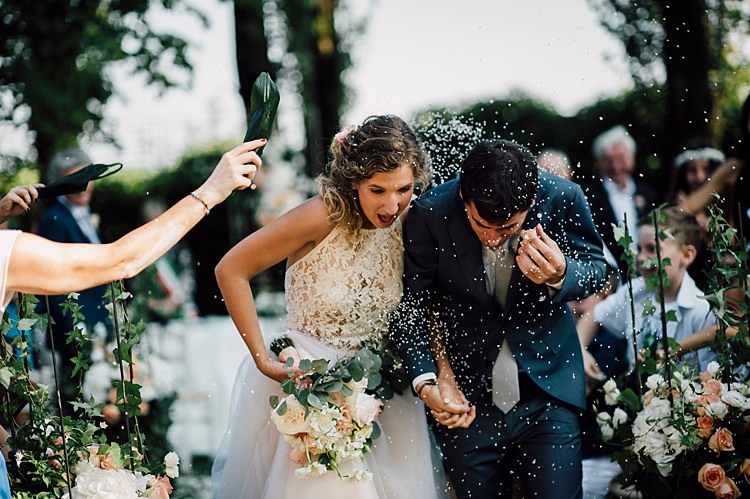 Ceremony Bride Lace Halter-Neck Top Tulle Skirt Bouquet White Peach Roses Peonies Groom Grey Suit Silver Tie Guests Outdoor Floral Countryside Wedding Veneto http://serenagenovese.com/