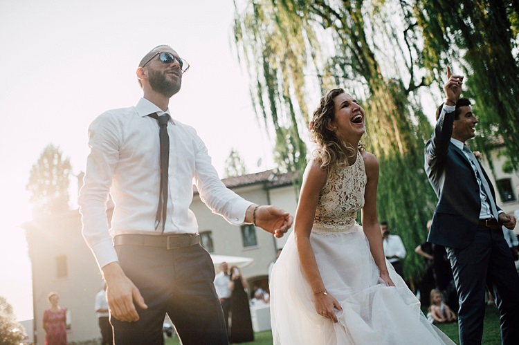 Bride Lace Halter-Neck Top Tulle Skirt Groom Grey Suit Silver Tie Guests Laughs Outdoor Floral Countryside Wedding Veneto http://serenagenovese.com/