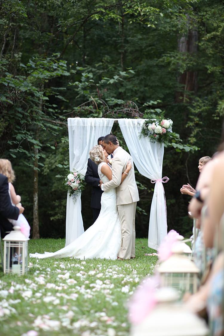 Outdoor Ceremony Bride Lace Mermaid Bridal Gown With Straps Floral Hairpiece Groom Beige Suit White Curtains Floral Bouquets Hydrangeas Roses Flower Petals Candle Lanterns Guests Trees Grass Soft Romantic Woodland Wedding Tennessee http://www.jessicaleephotographicart.com/