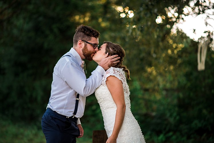 First Look Bride Lace Bridal Gown With Buttons Soft Curls Hairstyle Groom Navy Pants Suspenders Cream Bow Tie Glasses Kiss Trees Grass Ethereal Boho Wedding Ideas http://perfectcapturephoto.com/