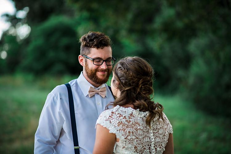 First Look Groom Light Blue Shirt Cream Bow Tie Navy Suspenders Bride Lace Bridal Gown With Buttons Soft Curls Hairstyle Trees Grass Ethereal Boho Wedding Ideas http://perfectcapturephoto.com/