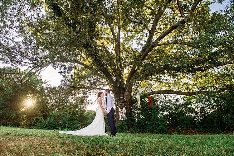 Bride Lace Bridal Gown With Buttons Groom Navy Pants Suspenders Hanging Dreamcatchers Tree Grass Ethereal Boho Wedding Ideas http://perfectcapturephoto.com/