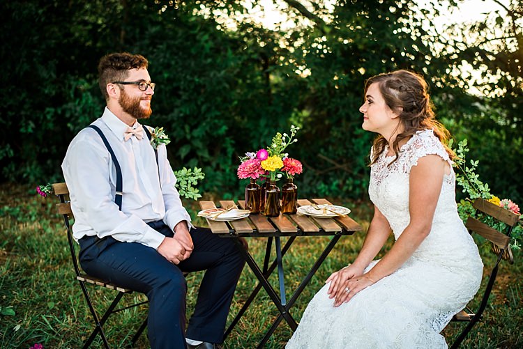 Bride Lace Bridal Gown With Buttons Groom Navy Pants Suspenders Cream Bow Tie Greenery Buttonhole Table Multicoloured Florals Brown Glass Vases Trees Grass Ethereal Boho Wedding Ideas http://perfectcapturephoto.com/