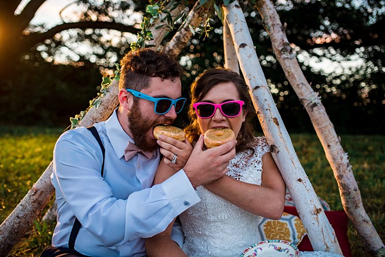 Bride Lace Bridal Gown With Buttons Groom Navy Pants Suspenders Cream Bow Tie His And Her Pink Blue Sunglasses Donuts Teepee Grass Trees Ethereal Boho Wedding Ideas http://perfectcapturephoto.com/