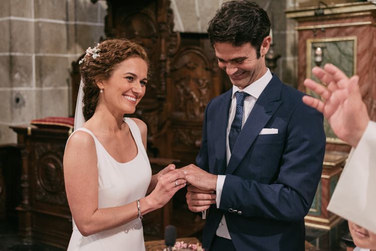 Church Ceremony Bride Round Neck Crepe Tulle Bridal Gown Floral Hairpiece Veil Groom Navy Blue Suit Grey Vest Polka Dot Tie Ring Exchange Smiles Romantic Bohemian Spain Wedding http://saralobla.com/