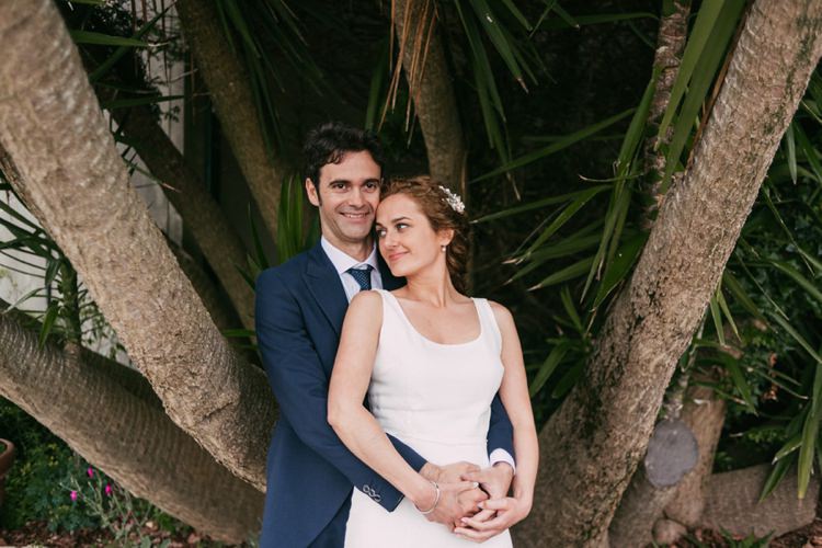 Bride Round Neck Crepe Tulle Bridal Gown Floral Hairpiece Groom Navy Blue Suit Grey Vest Polka Dot Tie Outdoors Palm Trees Romantic Bohemian Spain Wedding http://saralobla.com/
