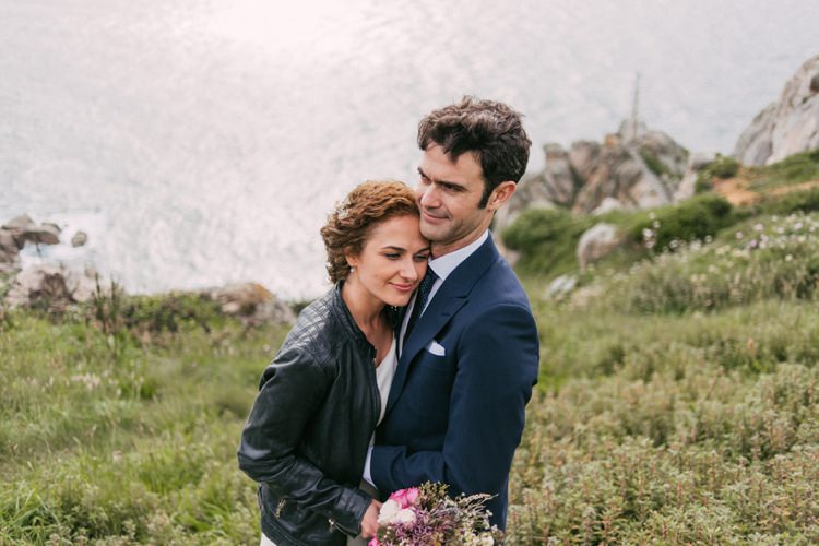 Bride Round Neck Crepe Tulle Bridal Gown Floral Hairpiece Leather Jacket Pastel Bouquet Roses Lavender Cream Pink Purple Groom Navy Blue Suit Grey Vest Polka Dot Tie Green Hills Ocean Romantic Bohemian Spain Wedding http://saralobla.com/