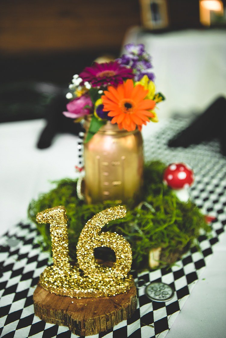Reception Table Setting Glitter Table Number Gold Mason Jar Multicoloured Florals Gerbra Baby's Breath Greenery Mushroom Black And White Check Tablecloth Alice in Wonderland Wedding Pennsylvania http://www.julieflorophotography.com/