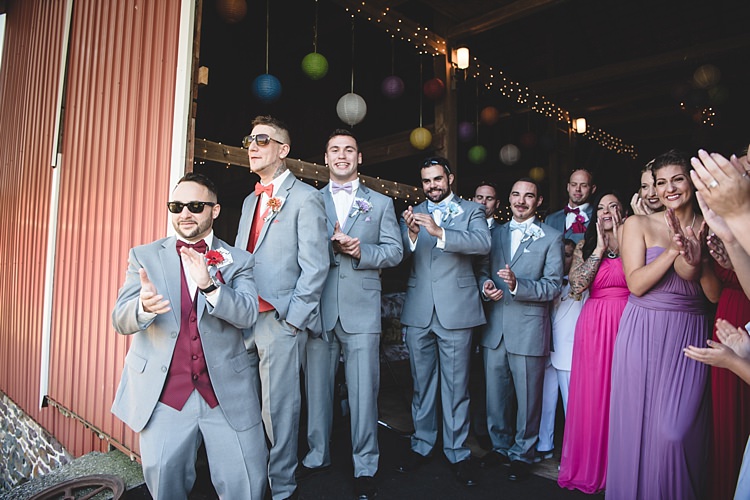 Groomsmen Grey Suits Multicoloured Vests Bowties Bridesmaids Colourful Dresses Bright Hanging Lanterns Fairy Lights Barn Alice in Wonderland Wedding Pennsylvania http://www.julieflorophotography.com/