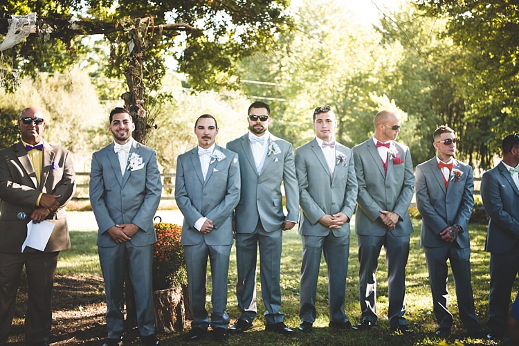 Outdoor Ceremony Groom Grey Suit White Bowtie Groomsmen Grey Suits Multicoloured Vests Bowties Celebrant Alice in Wonderland Wedding Pennsylvania http://www.julieflorophotography.com/