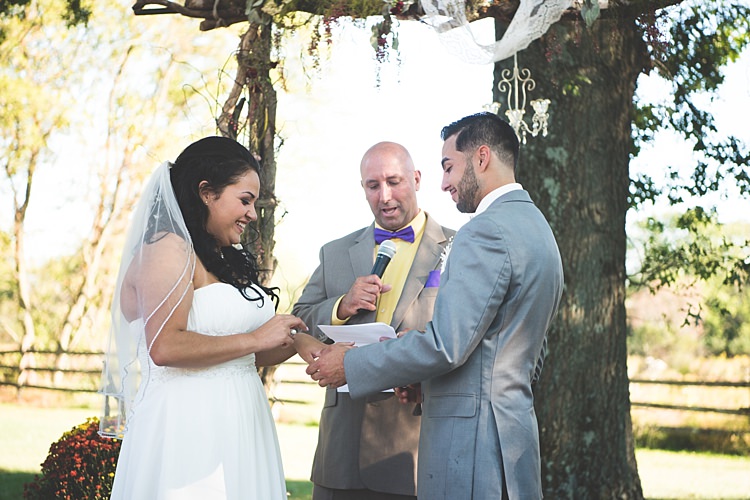 Outdoor Ceremony Decorated Arch Bride Strapless Gown With Train Veil Groom Grey Suit White Bowtie Celebrant Leafy Tree Potted Flowers Alice in Wonderland Wedding Pennsylvania http://www.julieflorophotography.com/