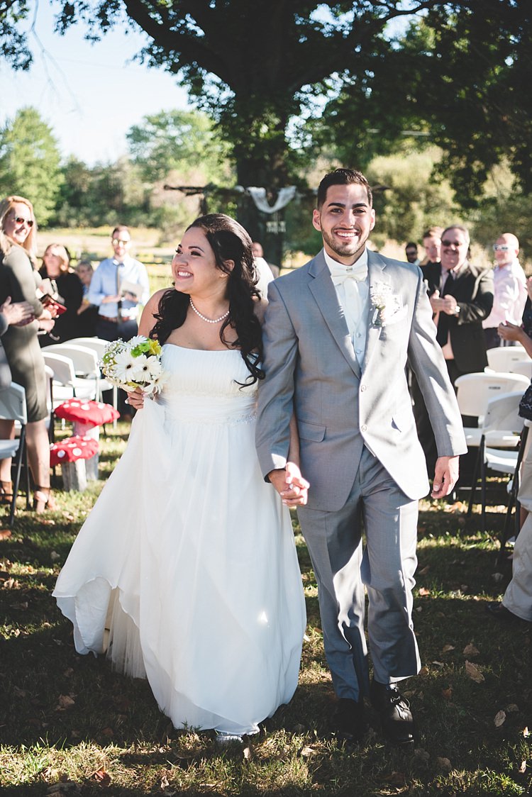 Outdoor Ceremony Decorated Arch Bride Strapless Gown With Train Veil Bouquet White Yellow Gerbera Groom Grey Suit White Bowtie Guests Smiles Alice in Wonderland Wedding Pennsylvania http://www.julieflorophotography.com/