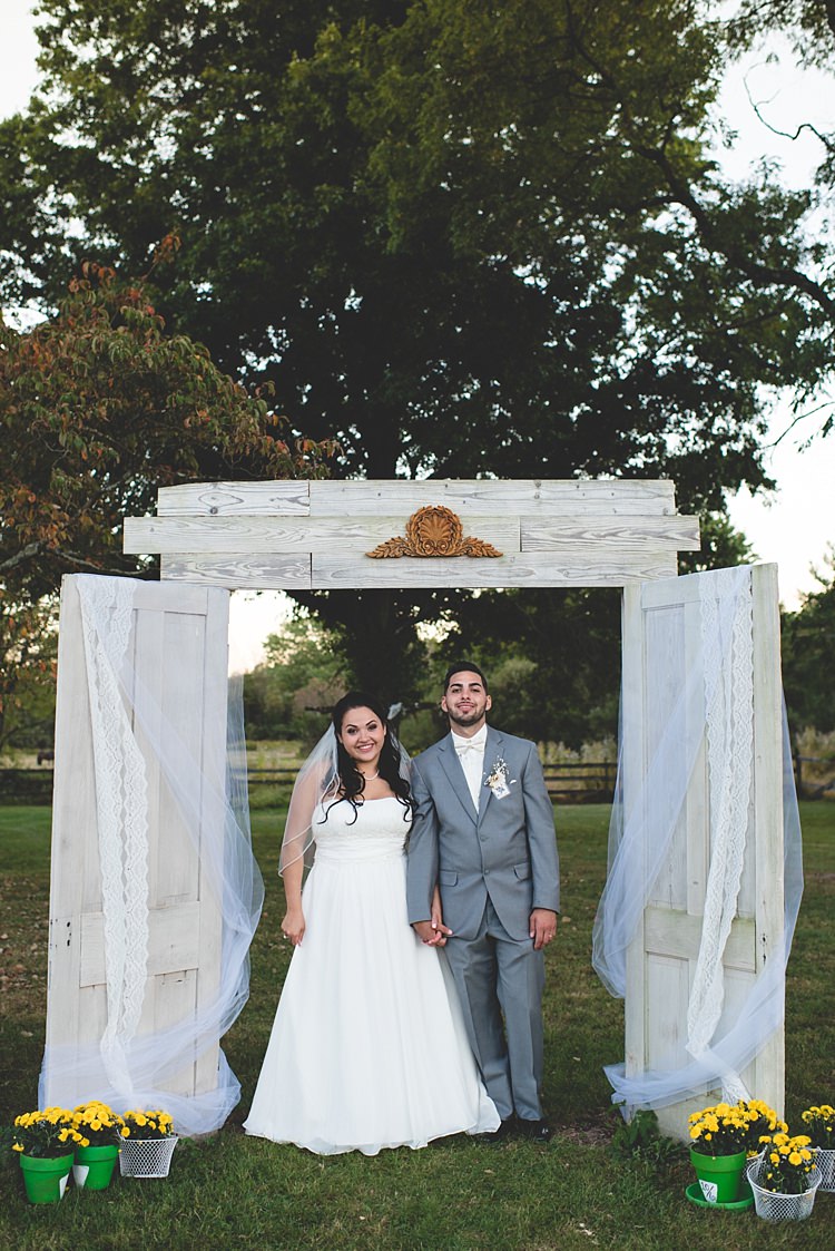 Bride Strapless Gown With Train Veil Groom Grey Suit White Bowtie Decorated Wooden Doorframe Tulle Potted Yellow Flowers Alice in Wonderland Wedding Pennsylvania http://www.julieflorophotography.com/