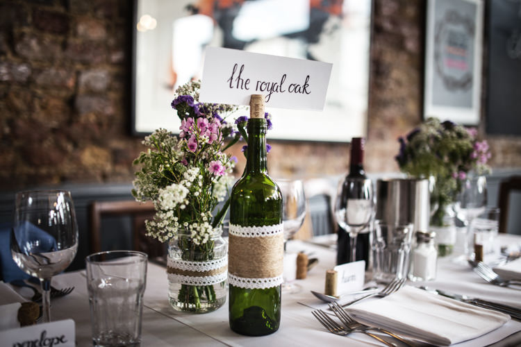 Wine Bottle Table Names Mismatched London Pub Wedding http://www.olliverphotography.com/