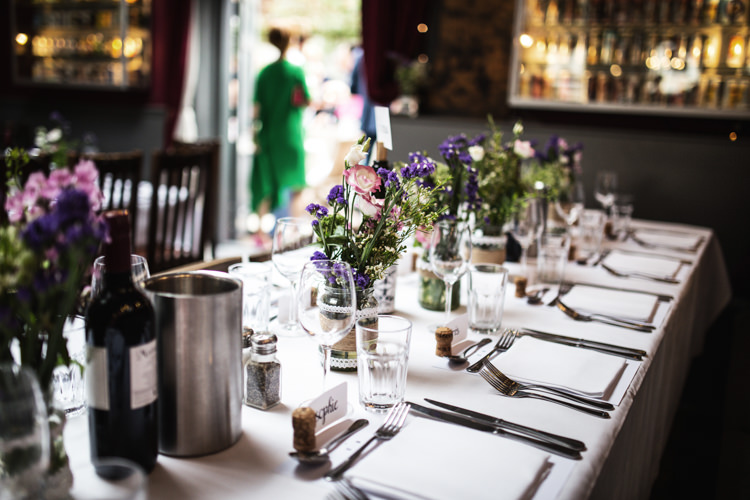 Table Flowers Bottles Jars Mismatched London Pub Wedding http://www.olliverphotography.com/