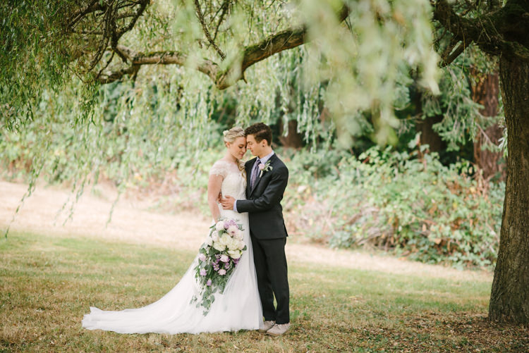 Bride Cap Sleeve Backless Tulle Bridal Gown Cascading Bouquet White Purple Chrysanthemums Roses Groom Charcoal Suit Purple Patterned Tie Toms Shoes Trees Grass Magical Fairytale Forest Wedding Washington http://karissaroe.com/