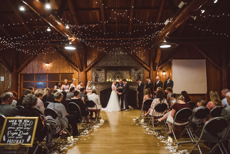 Wooden Hall Ceremony Hanging Fairy Lights Bride Groom Celebrant Bridesmaids Groomsmen Guests Magical Fairytale Forest Wedding Washington http://karissaroe.com/