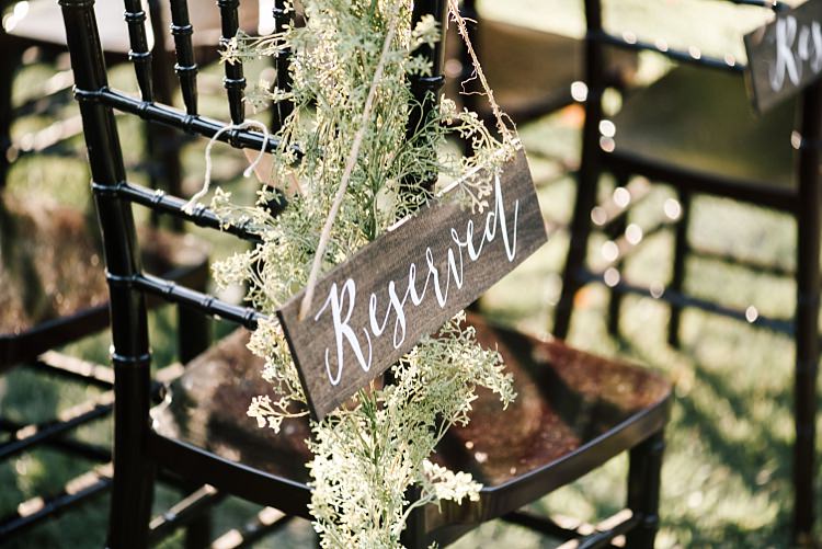 Outdoor Ceremony Seating Wooden DIY Reserved Sign White Calligraphy Fresh Wild Florals Wooden Chairs Whimsical Boho Outdoor Wedding Alabama http://belightphotography.com/