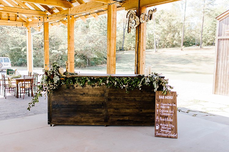 Reception Wooden Bar Fresh Wild Florals Eucalyptus Lit Bar Sign Wooden DIY Drinks Menu Sign White Calligraphy Barn Reception Whimsical Boho Outdoor Wedding Alabama http://belightphotography.com/