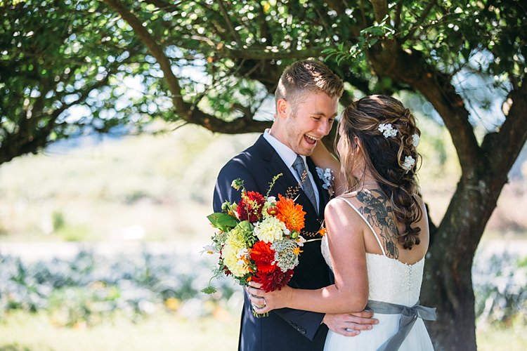 Bride Lace Tulle Bridal Gown Grey Sash Tattoo Bright Orange Red Yellow Bouquet Groom Navy Blue Suit Grey Tie Trees Organic Farm Wedding Washington http://www.katiedayphotos.com/
