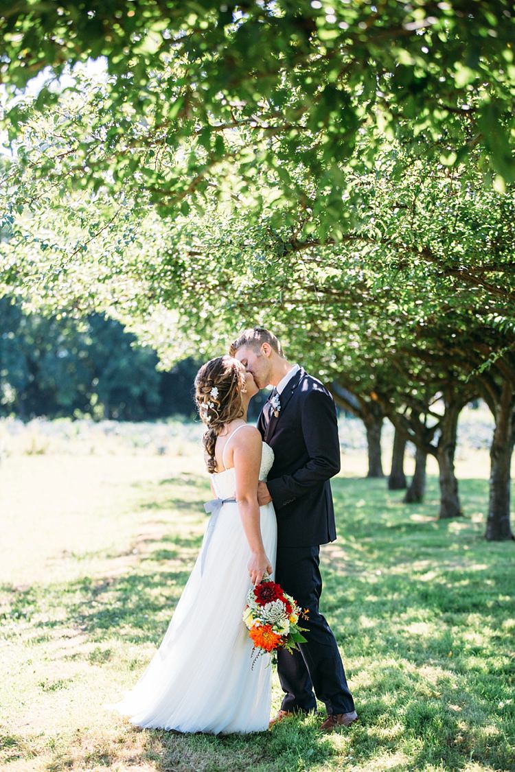 Bride Lace Tulle Bridal Gown Grey Sash Bright Orange Red Yellow Bouquet Groom Navy Blue Suit Grey Tie Trees Organic Farm Wedding Washington http://www.katiedayphotos.com/