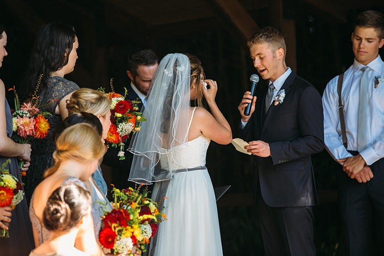 Outdoor Ceremony Bride Lace Tulle Bridal Gown Grey Sash Veil Groom Navy Blue Suit Grey Tie Floral Button Hole Bridesmaids Bright Orange Red Yellow Bouquets Organic Farm Wedding Washington http://www.katiedayphotos.com/