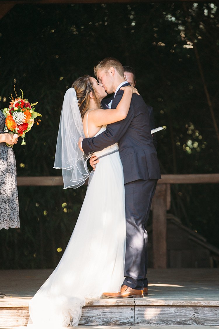 Outdoor Ceremony Bride Lace Tulle Bridal Gown Grey Sash Veil Groom Navy Blue Suit Grey Tie Floral Button Hole Kiss Organic Farm Wedding Washington http://www.katiedayphotos.com/
