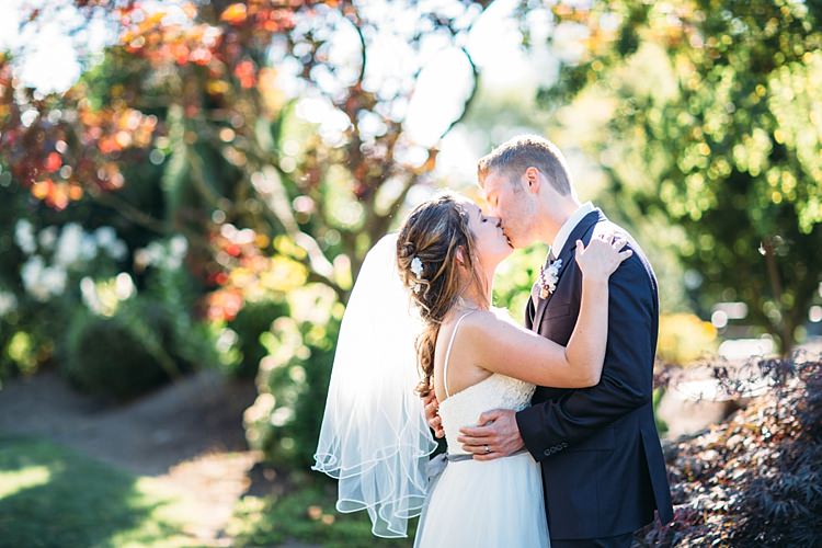 Bride Lace Tulle Bridal Gown Grey Sash Loose Curls Hairstyle Flowers Groom Navy Blue Suit Grey Tie Floral Button Hole Kiss Organic Farm Wedding Washington http://www.katiedayphotos.com/