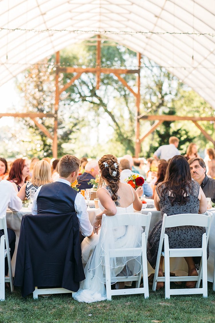 Outdoor Reception Marquee Bride Lace Tulle Bridal Gown Grey Sash Loose Curls Hairstyle Flowers Groom Navy Blue Suit Vest Guests White Chairs Organic Farm Wedding Washington http://www.katiedayphotos.com/
