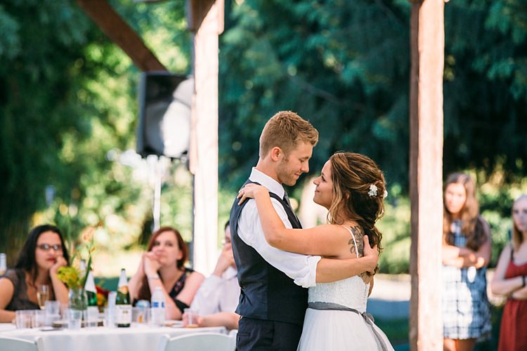 Outdoor Reception First Dance Bride Lace Tulle Bridal Gown Grey Sash Loose Curls Hairstyle Flowers Groom Navy Blue Vest Grey Tie Guests Organic Farm Wedding Washington http://www.katiedayphotos.com/