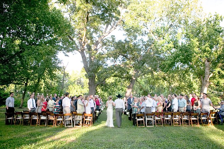 Outdoor Ceremony Bride Beaded Jenny Packham Bridal Gown Father Entrance Guests Dark Wooden Chairs Trees Gold & Peach Riverside Garden Wedding http://kellyhornberger.com/