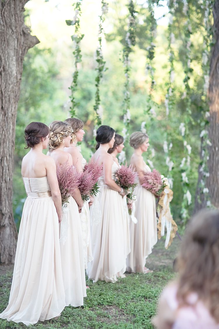 Outdoor Ceremony Bridesmaids Cream Sweetheart Dresses Embellished Sashes Pink Bouquets Long Ribbons Hanging Floral Décor Gold & Peach Riverside Garden Wedding http://kellyhornberger.com/