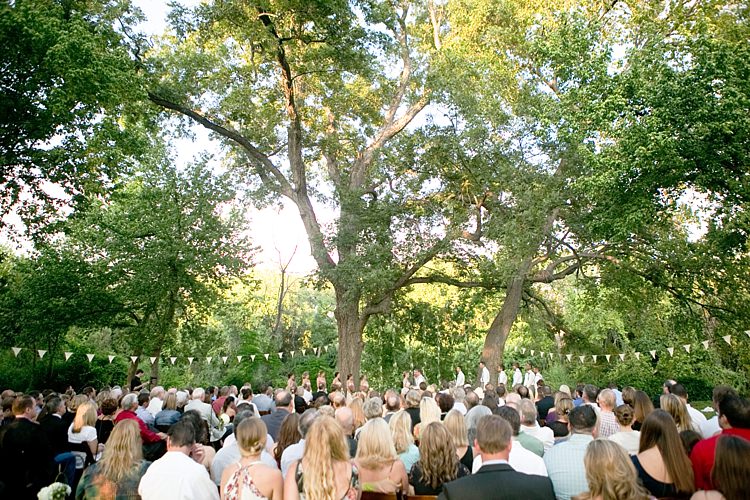 Outdoor Ceremony Bride Groom Bridal Party Hanging Floral Décor Bunting Trees Guests Gold & Peach Riverside Garden Wedding http://kellyhornberger.com/
