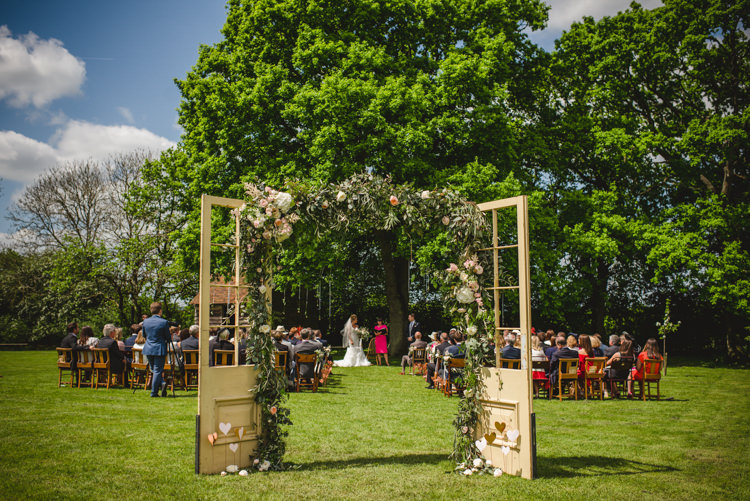 Door Frame Backdrop Flowers Foliage Magical Fun Outdoor Barn Wedding http://www.sophieduckworthphotography.com/