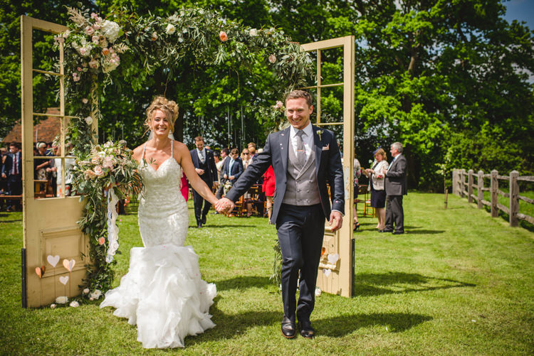Door Frame Backdrop Flowers Foliage Magical Fun Outdoor Barn Wedding http://www.sophieduckworthphotography.com/