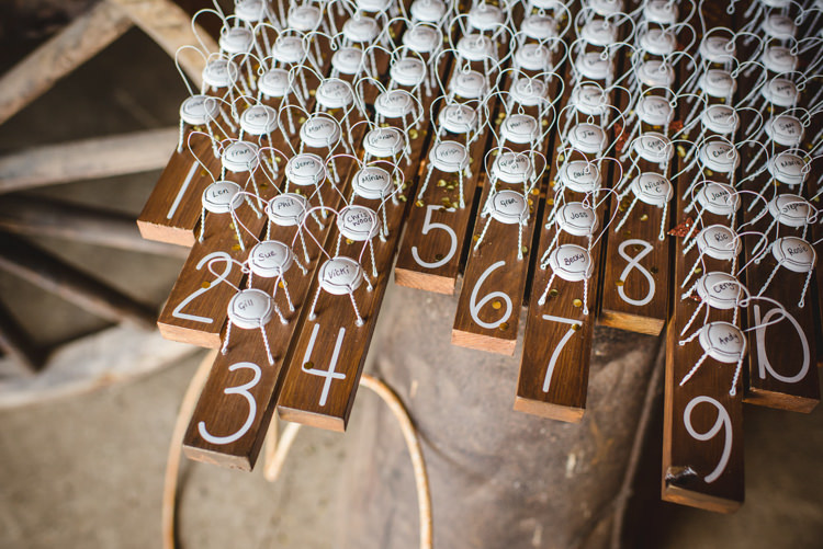 Seating Table Plan Bottle Tops Rustic Wooden Magical Fun Outdoor Barn Wedding http://www.sophieduckworthphotography.com/