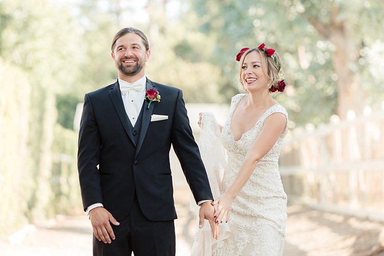 First Look Bride Lace V Neck Bridal Gown Red Maroon Rose Floral Crown Groom Black Suit White Shirt Bowtie Rose Buttonhole Luxe Outdoor Garden Wedding in California http://figlewiczphotography.com/