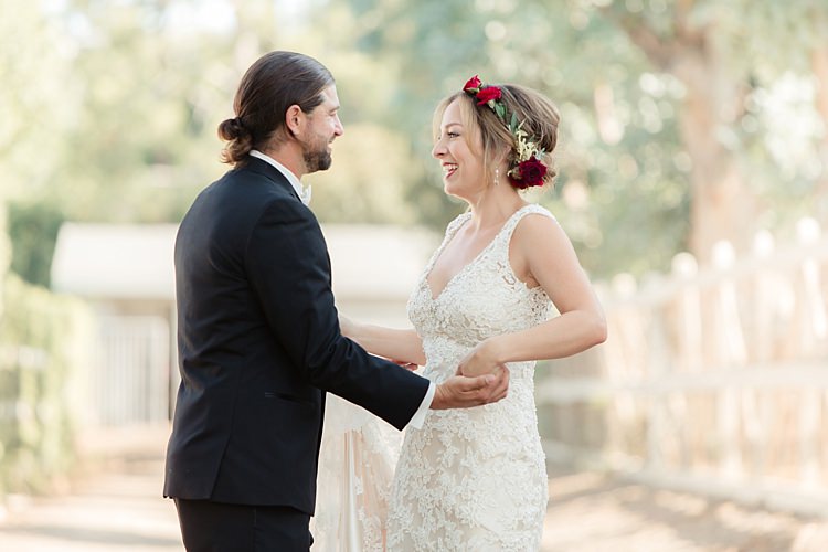 First Look Bride Lace V Neck Bridal Gown Red Maroon Rose Floral Crown Groom Black Suit White Shirt Bowtie Rose Buttonhole Luxe Outdoor Garden Wedding in California http://figlewiczphotography.com/