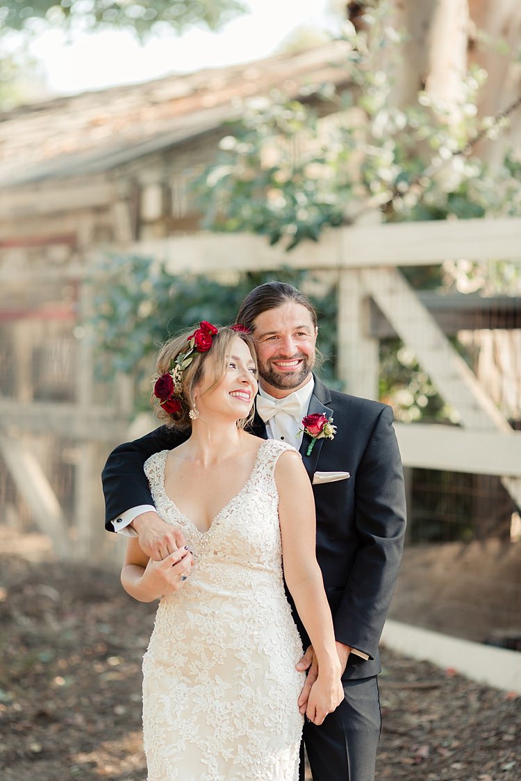 First Look Bride Lace V Neck Bridal Gown Red Maroon Rose Floral Crown Groom Black Suit White Shirt Bowtie Rose Buttonhole Luxe Outdoor Garden Wedding in California http://figlewiczphotography.com/