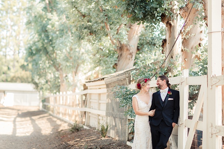 First Look Bride Lace V Neck Bridal Gown Red Maroon Rose Floral Crown Groom Black Suit White Shirt Bowtie Rose Buttonhole Luxe Outdoor Garden Wedding in California http://figlewiczphotography.com/