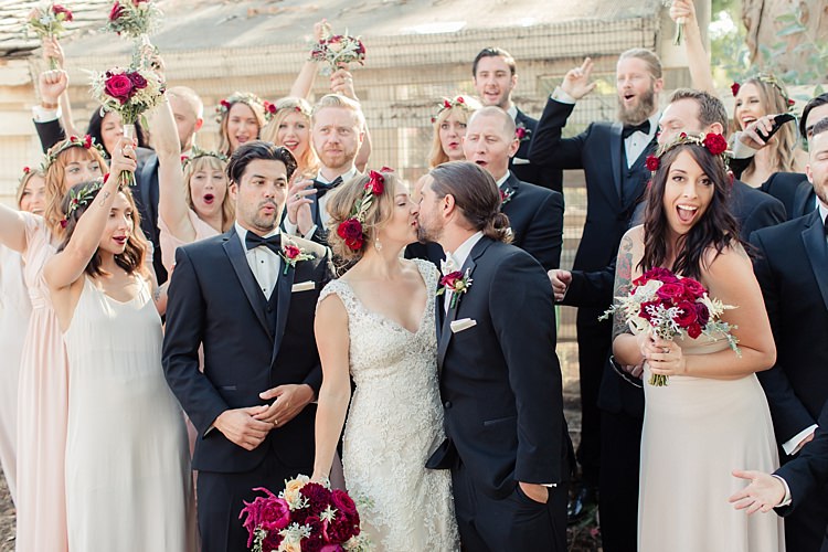 Bridal Party Bride Lace V Neck Bridal Gown Red Maroon Rose Floral Crown Bouquet Groom Black Suit White Shirt Bowtie Rose Buttonhole Bridesmaids Cream Dresses Floral Crowns Groomsmen Black Suits Black Bowties Luxe Outdoor Garden Wedding in California http://figlewiczphotography.com/