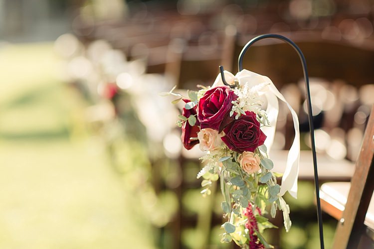 Outdoor Ceremony Aisle Decoration Hanging Florals Red Cream Roses White Ribbon Luxe Outdoor Garden Wedding in California http://figlewiczphotography.com/